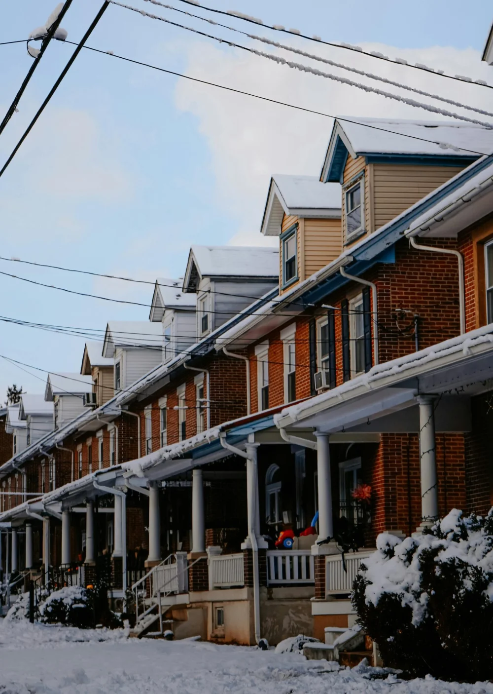 A street of red brick row homes in Philadelphia