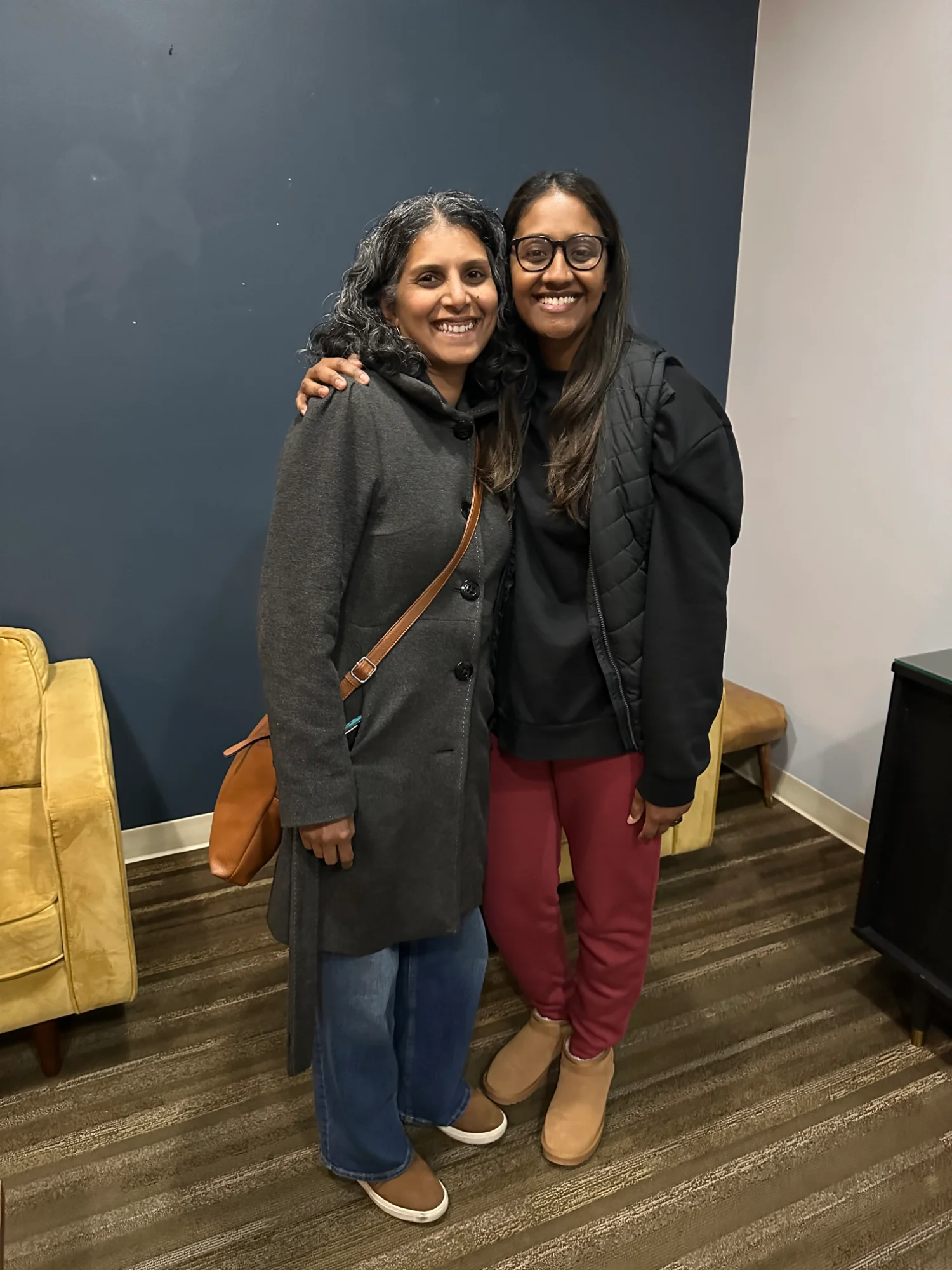 Two women smiling with their arms around each other